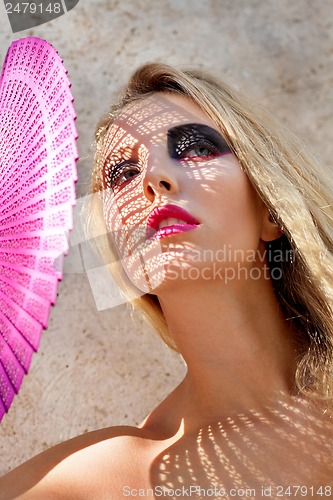 Image of young beautiful woman with smokey eyes and pink lips