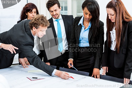 Image of business people discussing architecture plan sketch 