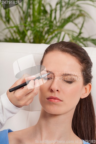 Image of young attractive woman makeup eyebrow powder shadow applying