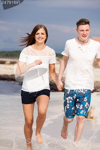 Image of happy young couple on the beach in summer holiday love