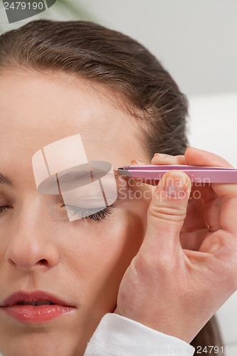 Image of young beautiful woman eyebrow plucking tweezers eyes hair 