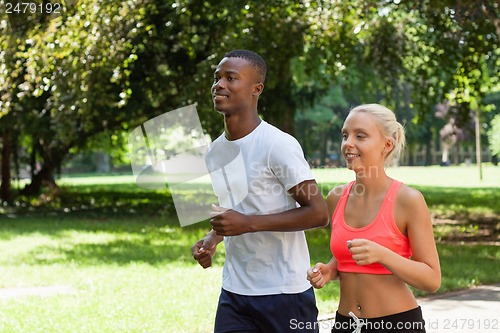 Image of young couple runner jogger in park outdoor summer