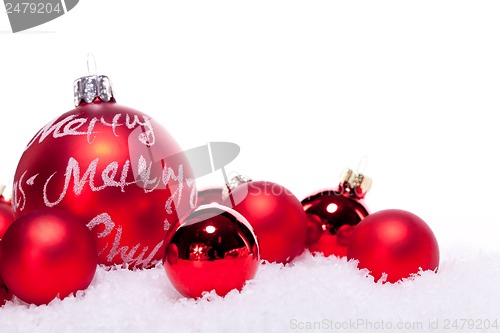 Image of christmas decoration festive red bauble in snow isolated