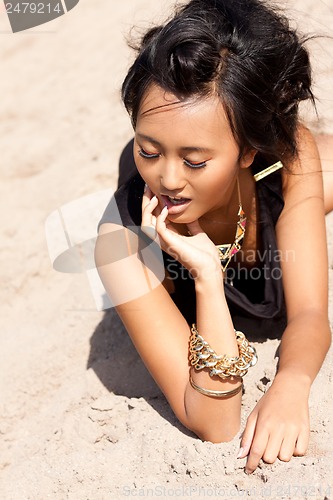 Image of beautiful asian woman with colorful makeup on the beach 