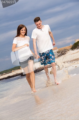 Image of happy young couple on the beach in summer holiday love