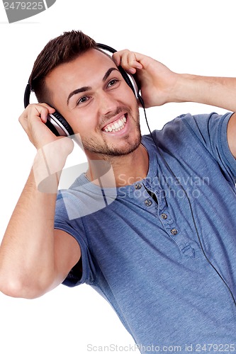 Image of young attractive man listening to music isolated portrait