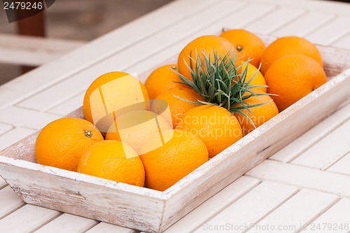 Image of fresh orange fruits decorative on table in summer