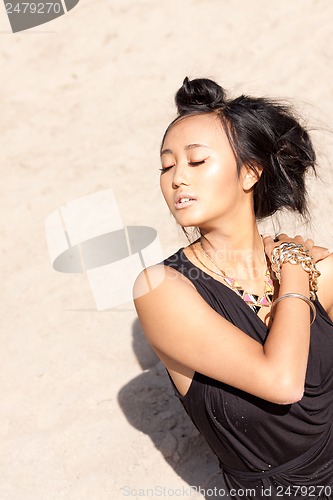 Image of beautiful asian woman with colorful makeup on the beach 