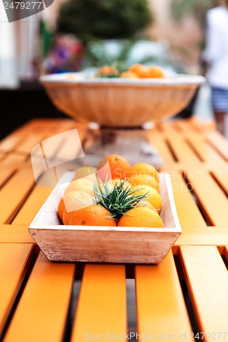 Image of fresh orange fruits decorative on table in summer