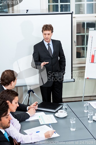 Image of business team on table in office conference