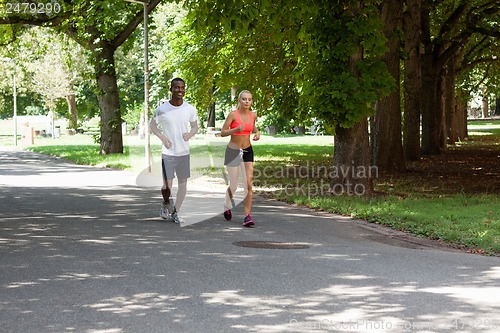 Image of young couple runner jogger in park outdoor summer