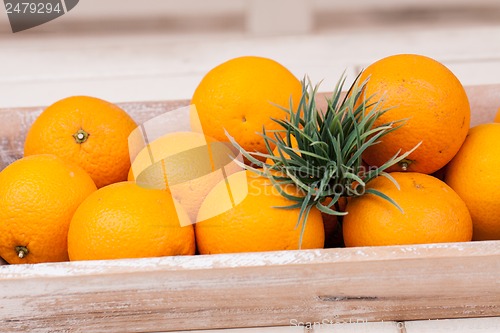 Image of fresh orange fruits decorative on table in summer