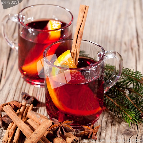 Image of hot tasty spicy mulled red wine with orange and cinnamon christmas 