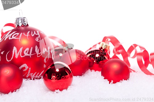 Image of christmas decoration festive red bauble in snow isolated