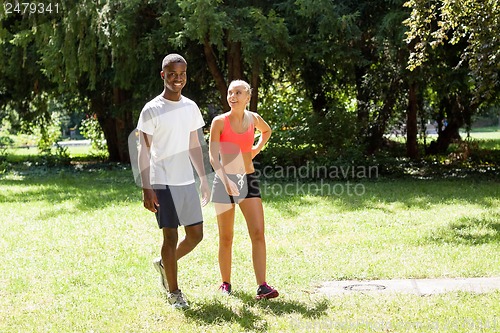 Image of young couple runner jogger in park outdoor summer