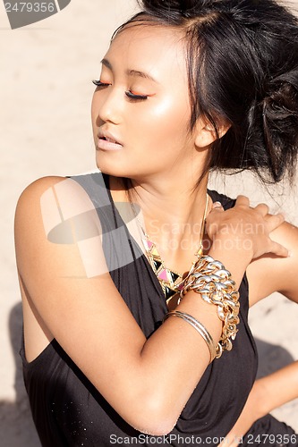 Image of beautiful asian woman with colorful makeup on the beach 