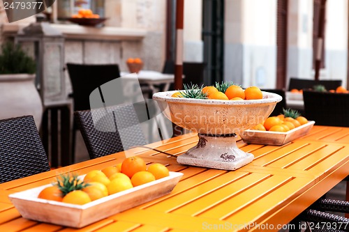 Image of fresh orange fruits decorative on table in summer