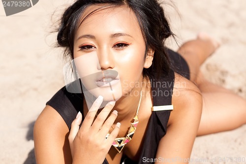 Image of beautiful asian woman with colorful makeup on the beach 