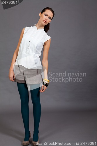 Image of young attractive brunette woman in studio portrait