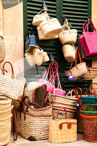 Image of handmade colorful straw handbags on market sale summer