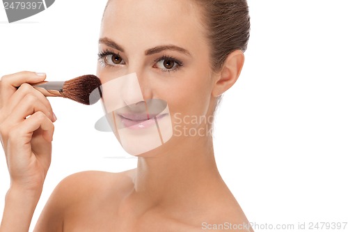 Image of apllying powder make up on face portrait