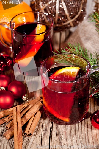 Image of hot tasty spicy mulled red wine with orange and cinnamon christmas 