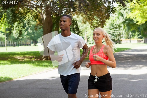 Image of young couple runner jogger in park outdoor summer