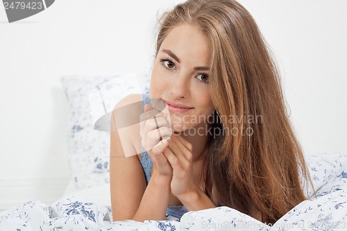 Image of young brunette woman lying in bed sleeping morning 