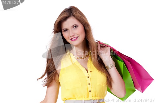 Image of attractive young woman with colorful shopping bags isolated