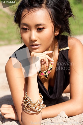Image of beautiful asian woman with colorful makeup on the beach 