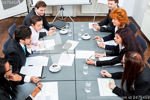 Image of business team on table in office conference