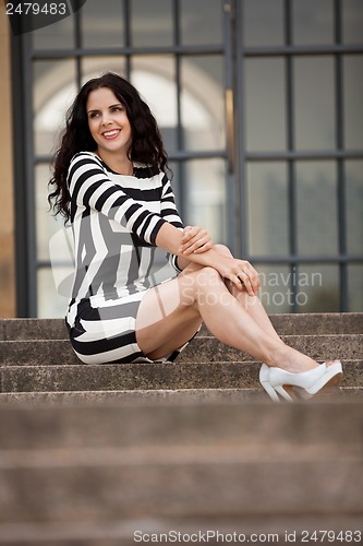 Image of beautiful woman in sexy dress on stairs summertime