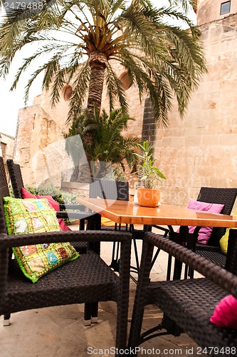 Image of table flower decoration in cafe restaurant outdoor in summer