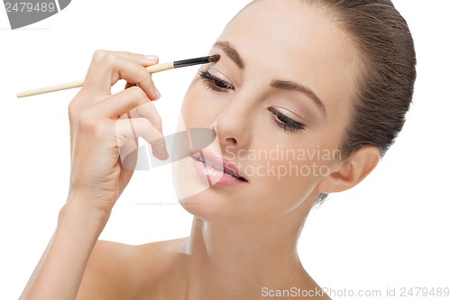 Image of doing the makeup brown eyeshadow on beautiful eyes