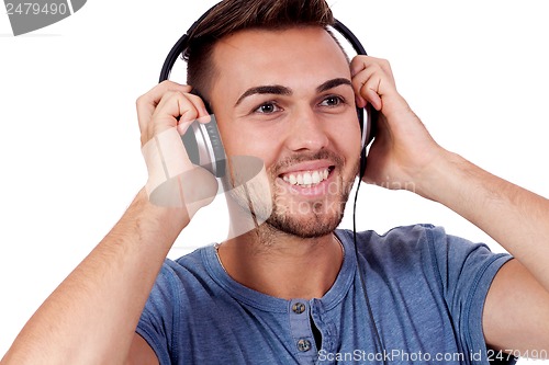 Image of young attractive man listening to music isolated portrait