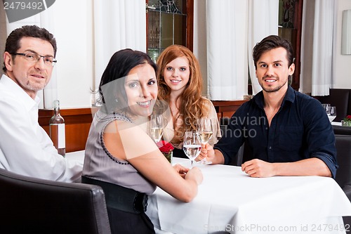 Image of smiling happy people in restaurant