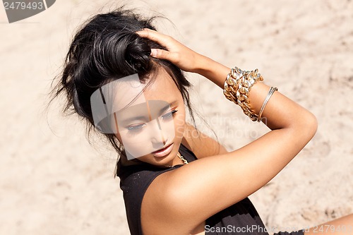 Image of beautiful asian woman with colorful makeup on the beach 