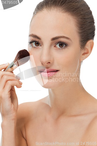 Image of apllying powder make up on face portrait