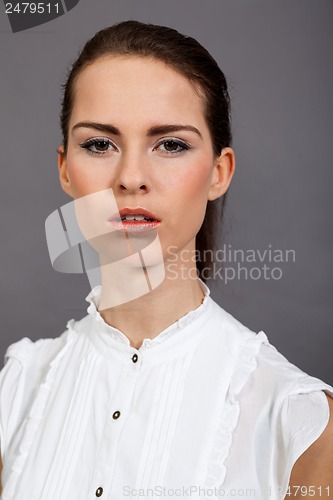 Image of young attractive brunette woman in studio portrait