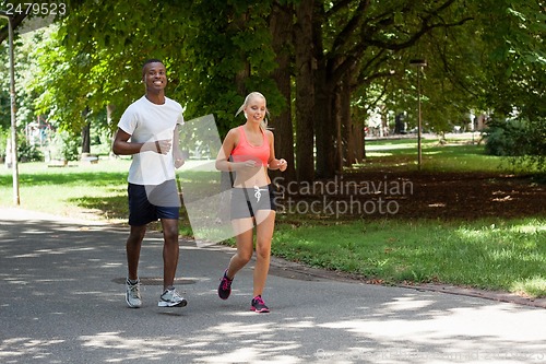 Image of young couple runner jogger in park outdoor summer