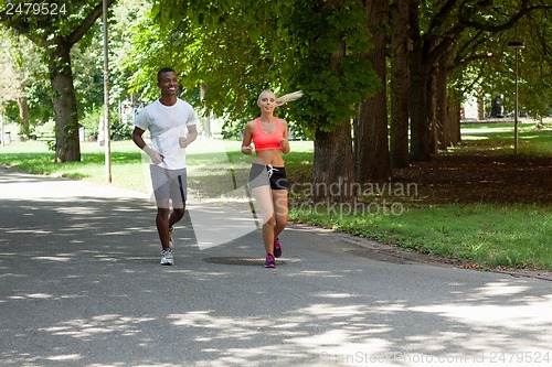 Image of young couple runner jogger in park outdoor summer