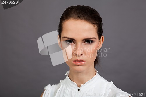 Image of young attractive brunette woman in studio portrait