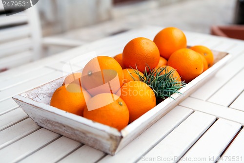 Image of fresh orange fruits decorative on table in summer