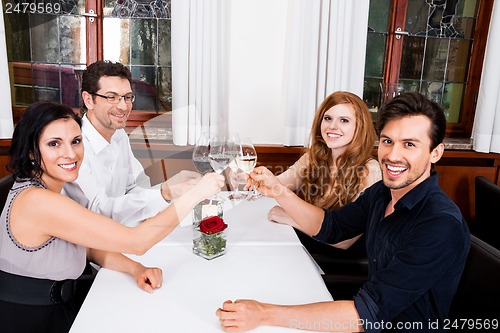Image of smiling happy people in restaurant