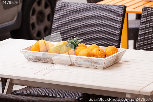 Image of fresh orange fruits decorative on table in summer