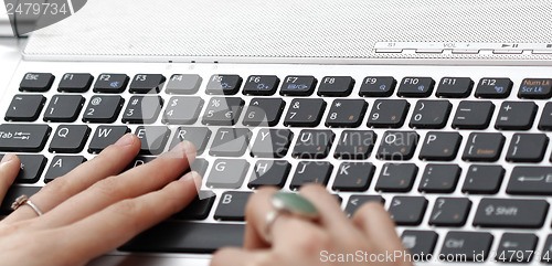 Image of Young woman working on laptop