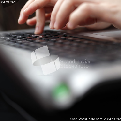 Image of Young woman working on laptop