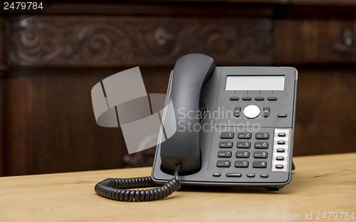 Image of phone on wooden table in living room