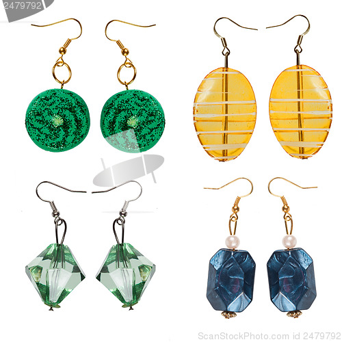 Image of Earrings made of plastic and glass on a white background. Collag