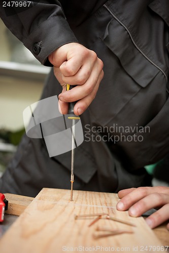 Image of Man with screwdriver